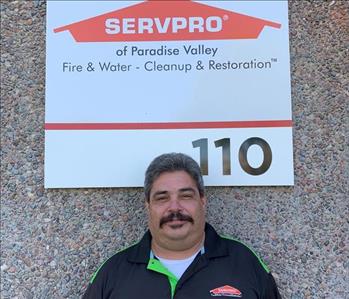Male employee RG in front of SERVPRO sign
