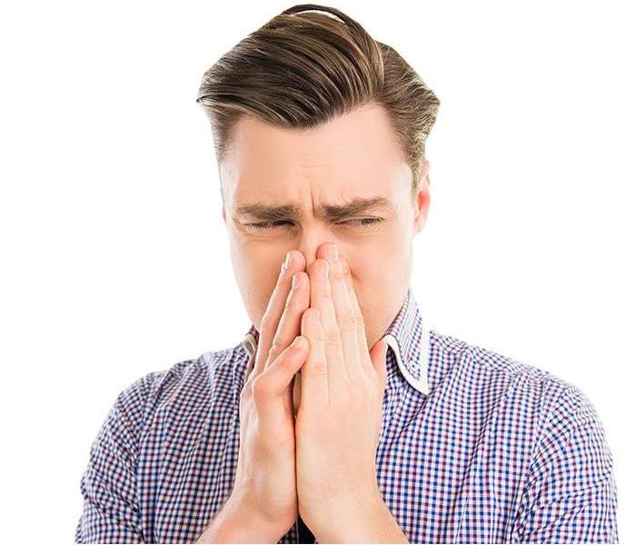 Man Holding Nose Due to Bad Odor